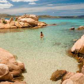 tourist-walking-in-the-crystal-clear-water-of-sard