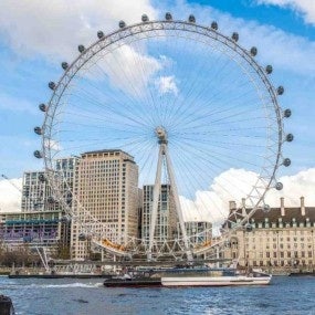 London eye ferris wheel towering over river thames and cityscape