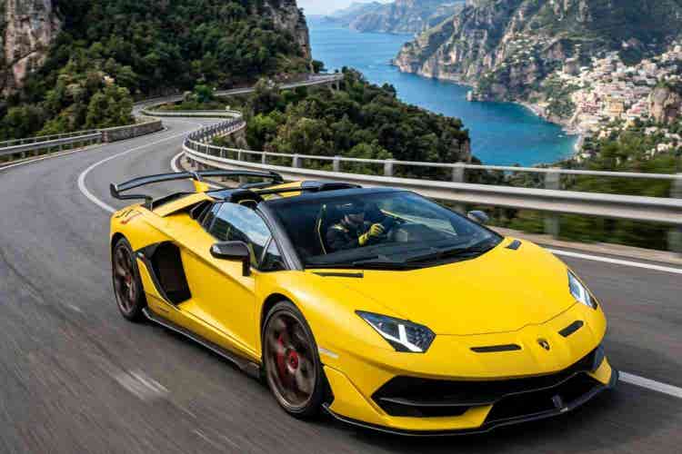 Lamborghini convertible driving on scenic mountain road