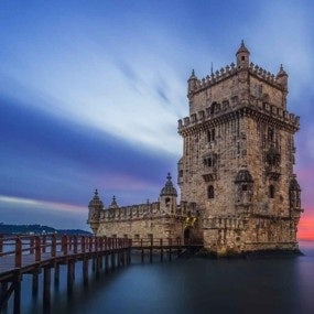 Medieval stone tower in dusky seascape